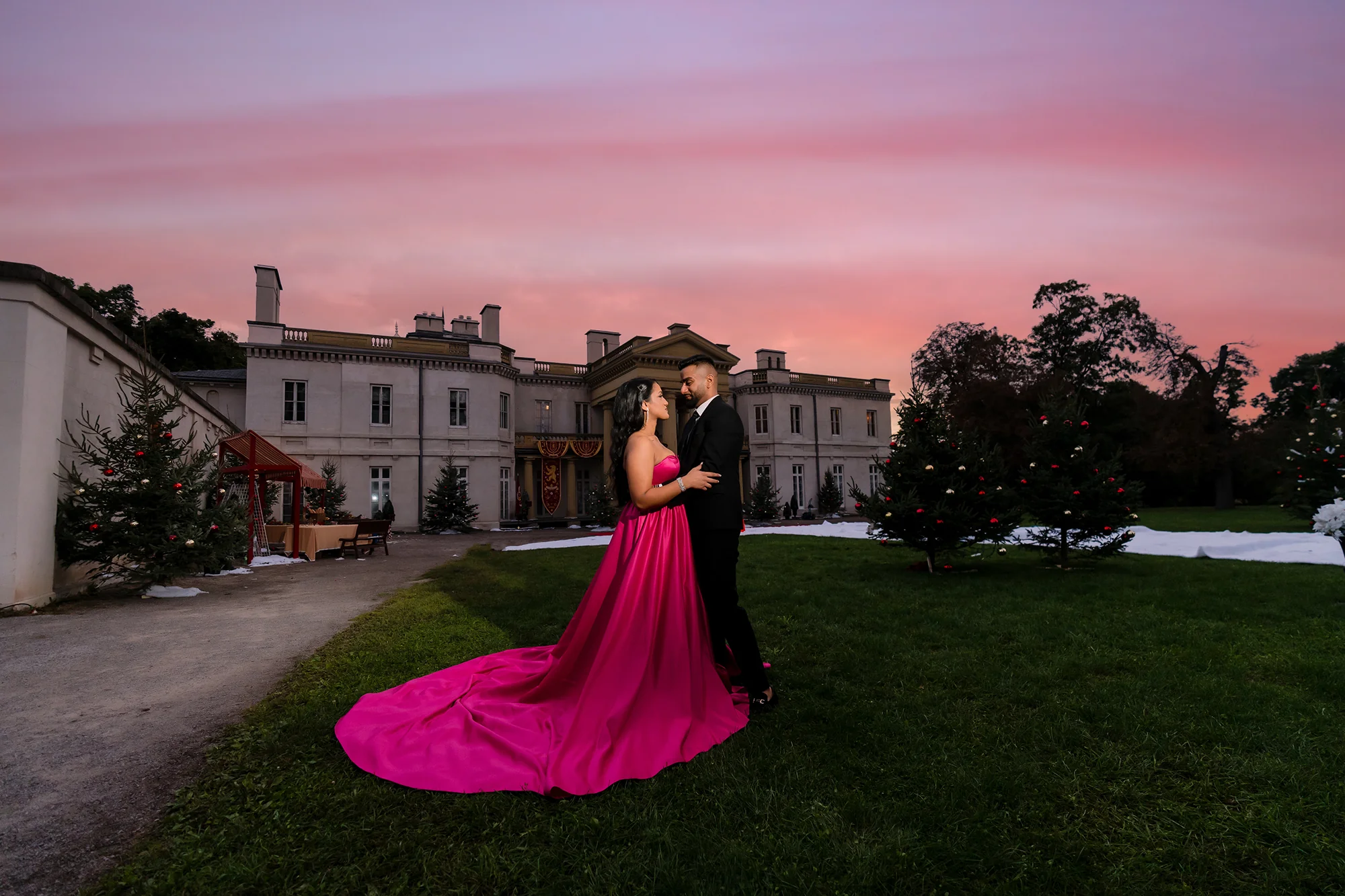 Pre-wedding photoshoot dress rental: hot pink satin long-train gown at historic estate sunset